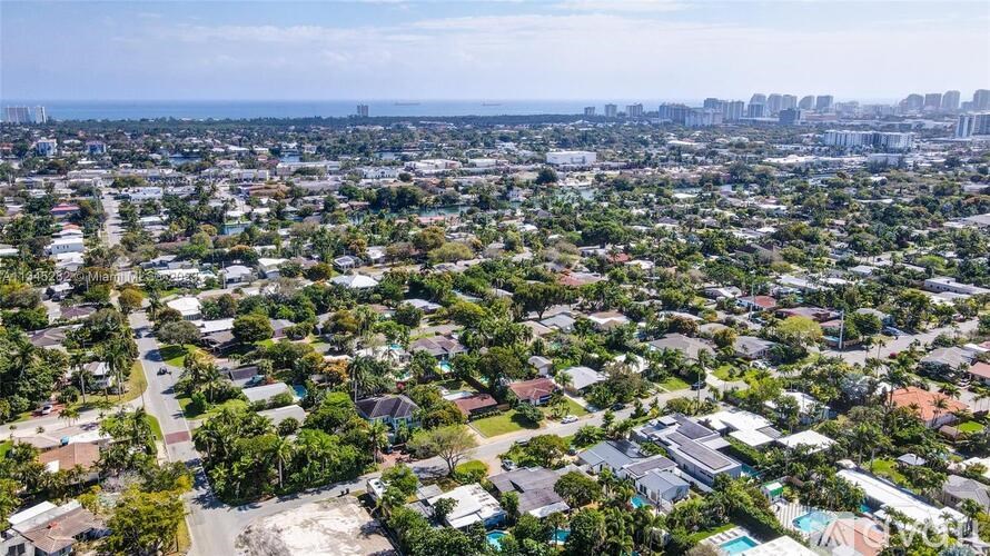 A bird's eye view of a residential area with houses and trees.