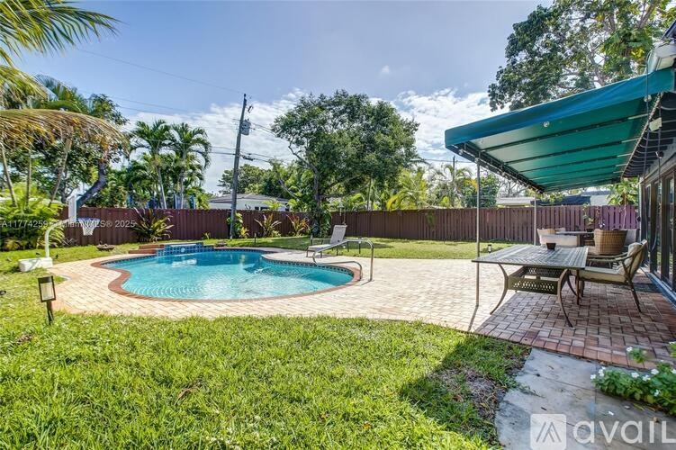 A backyard with a pool and a patio area.