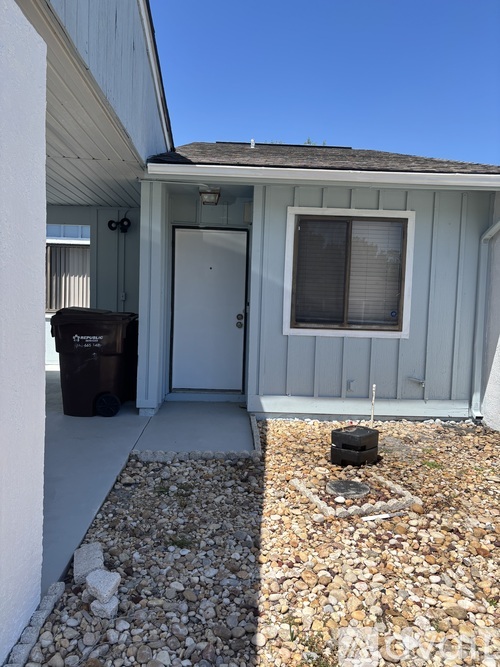 A small house with a white door and a window.