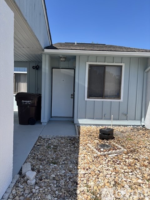 A small house with a white door and a window.