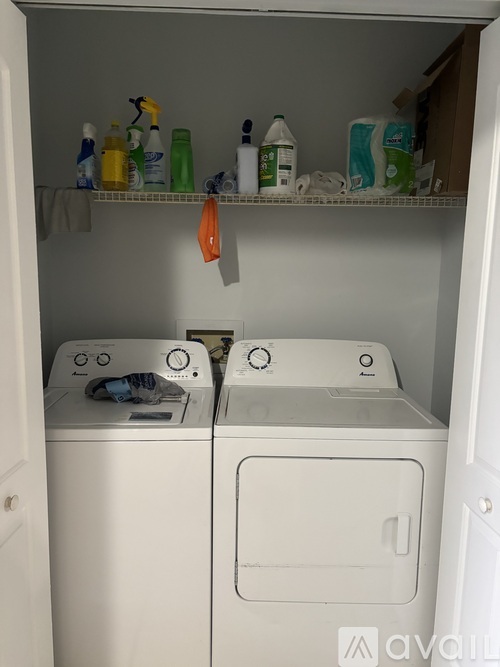 A small laundry room with a washer and dryer.