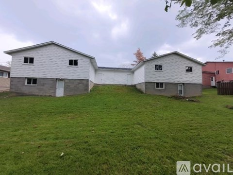 Two houses with a grassy yard in front.