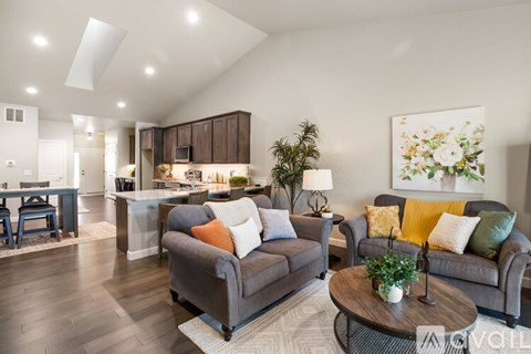 A living room with a grey couch and a coffee table.