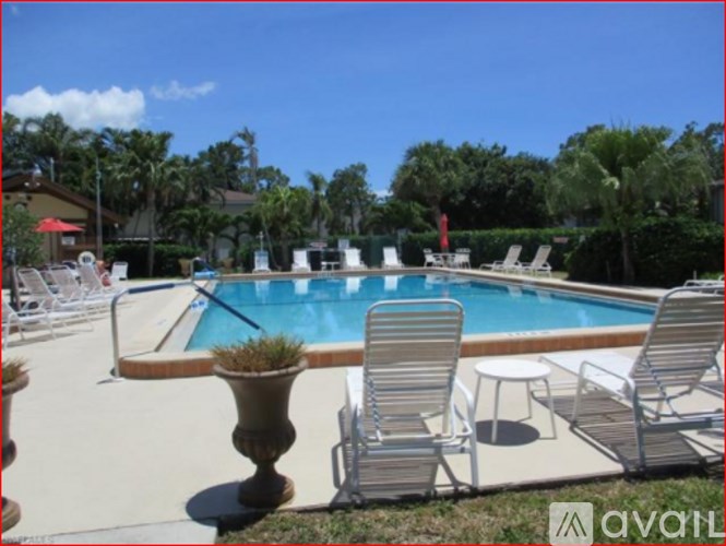 A pool with chairs around it.