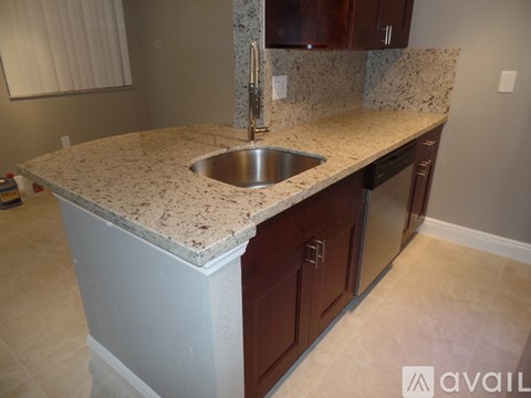 A kitchen island with a sink and a countertop.