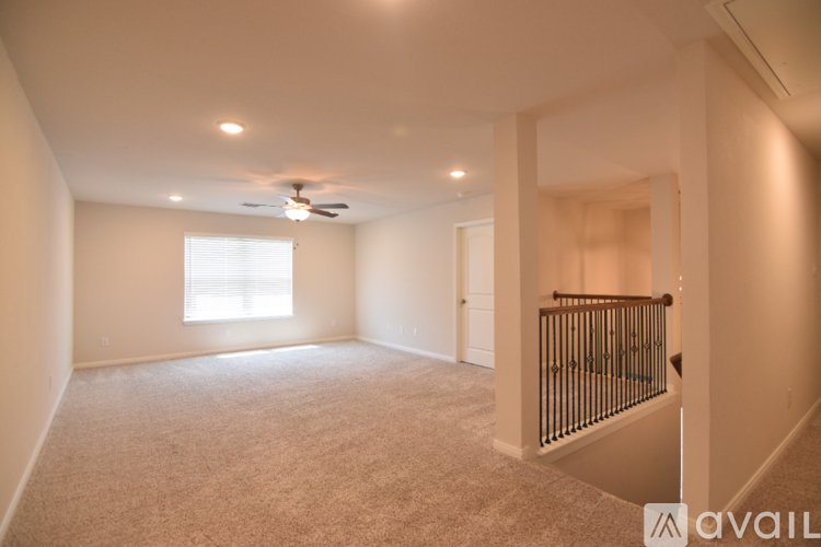 A bedroom with a bed, desk, and chair.