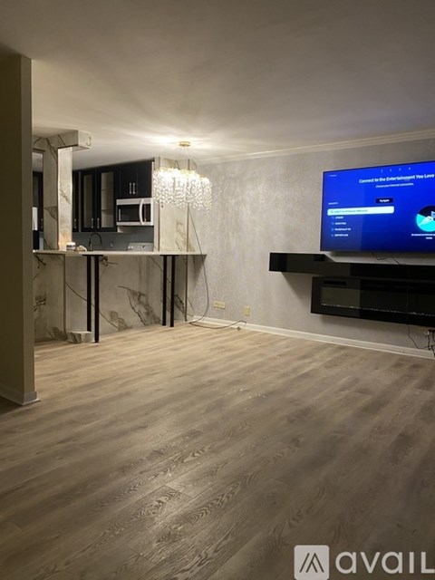 A modern living room with a flat screen TV mounted on the wall.
