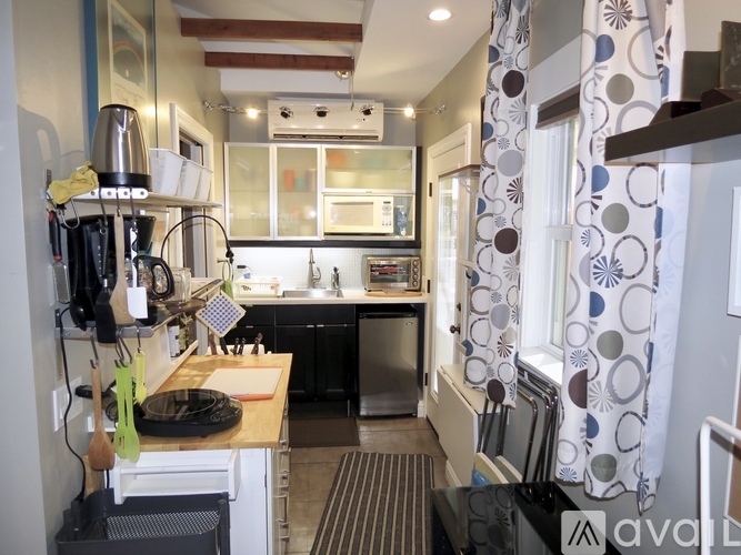 A kitchen with a black stove top oven and a black dishwasher.