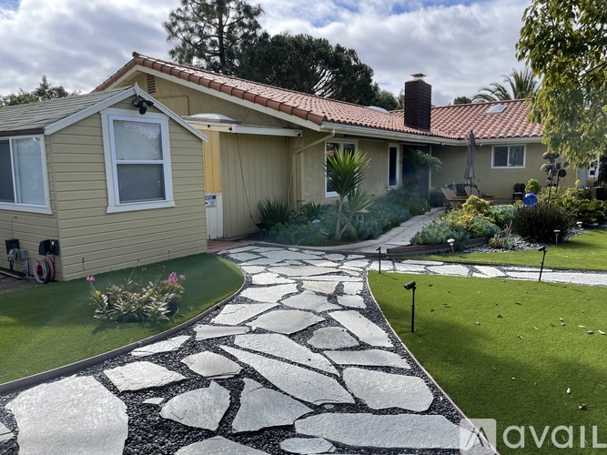A house with a stone pathway leading to the front door.