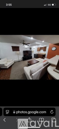 A living room with a white couch and a brown coffee table.