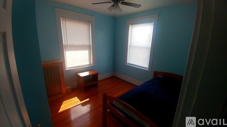 A room with blue walls and a ceiling fan.