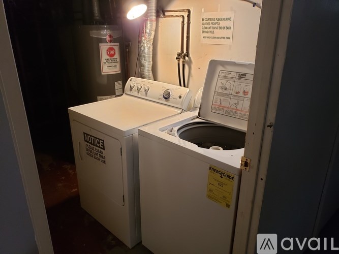 A white washing machine with a yellow sticker on it.