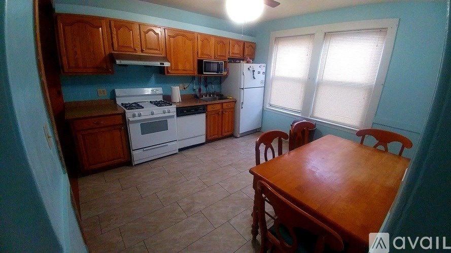A kitchen with a table and chairs.