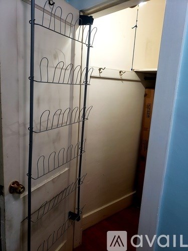 A white door with a metal rack on it.