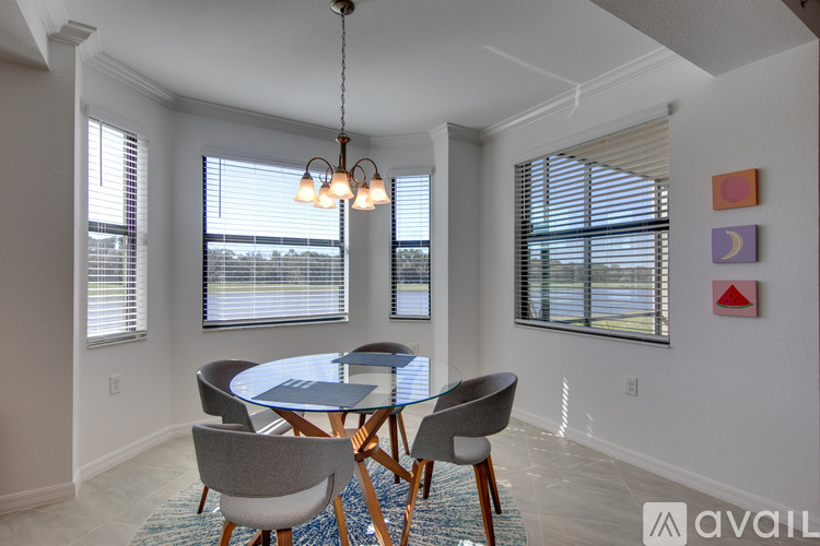 A dining room with a glass table and chairs.
