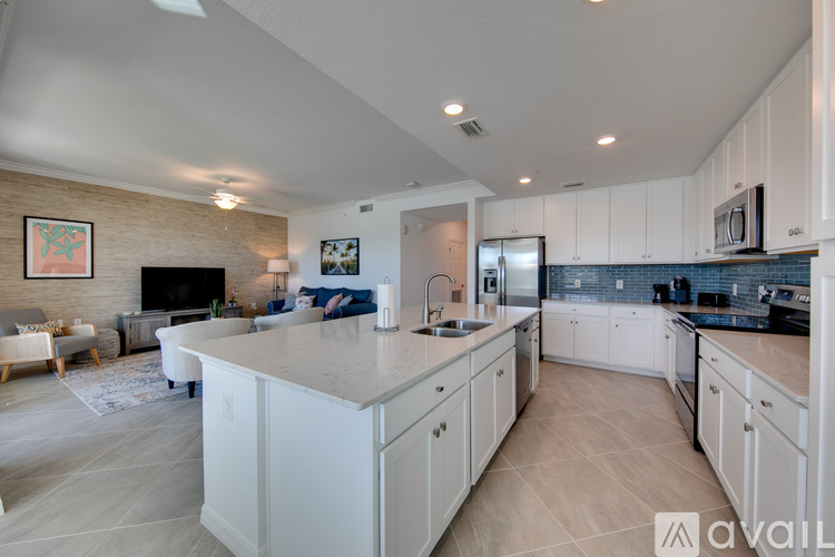 A modern kitchen with white cabinets and a large island.