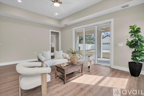 A living room with a white sofa and a wooden coffee table.