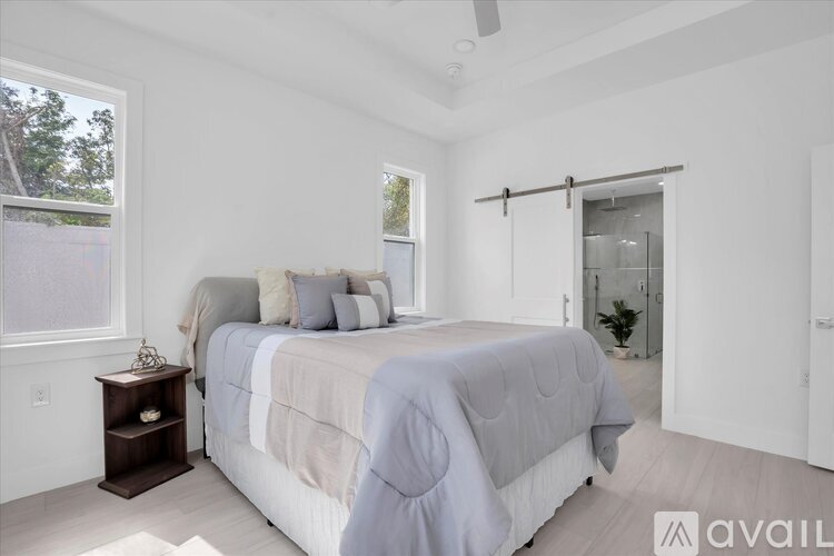 A bedroom with a large bed and a window.