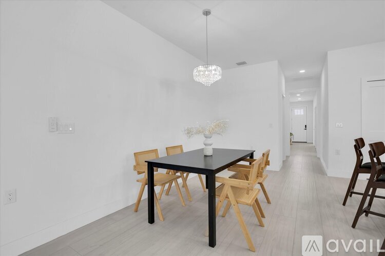 A dining room with a table and chairs.