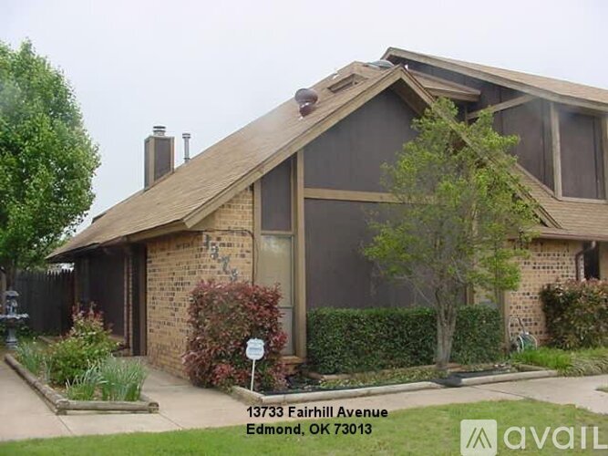 A house with a sign in front that says 13733 Fairhill Avenue Edmond, OK 73013.