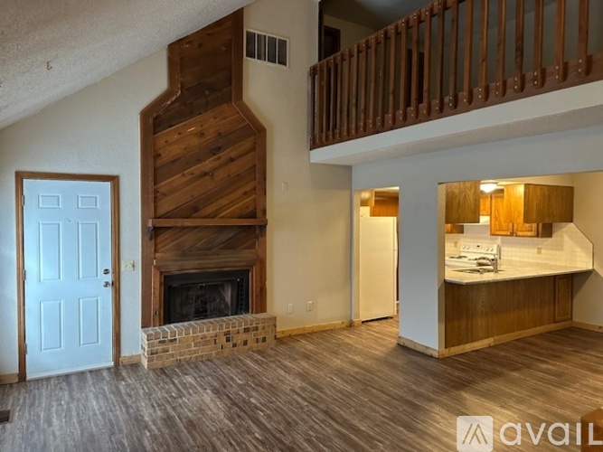 A living room with a fireplace and a balcony.