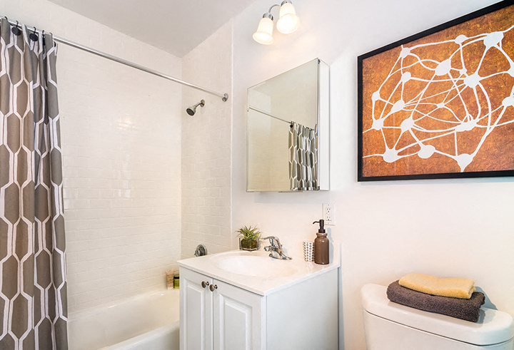 a bathroom with a shower and a sink and a mirror