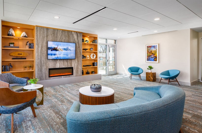 a living room with blue furniture and a fireplace