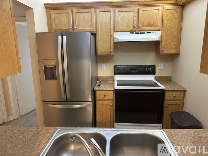 A kitchen with a stainless steel refrigerator and oven.