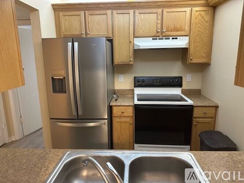 A kitchen with a stainless steel refrigerator and oven.