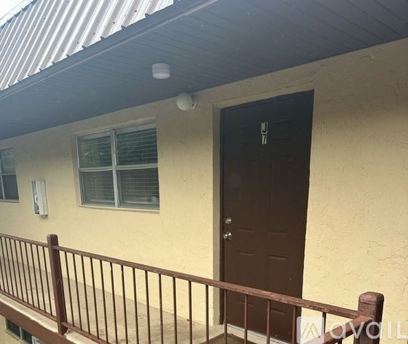 A house with a brown door and a brown railing.