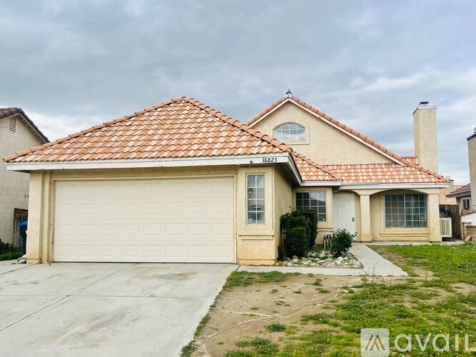 A house with a red tile roof and a garage door.