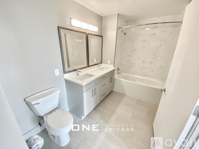 A bathroom with a toilet, sink, and bathtub.