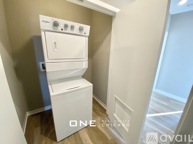 A white washer and dryer in a small room.