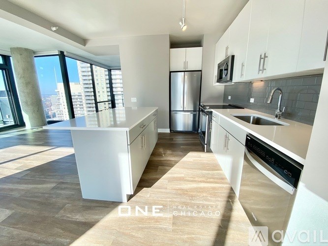 A modern kitchen with white appliances and a view of the city.
