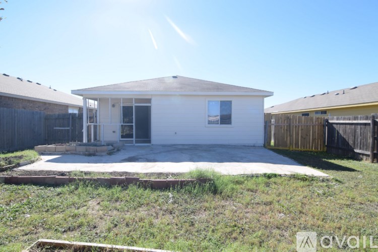 A house with a brown roof and a white wall is for sale.