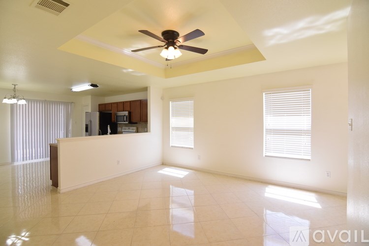 A kitchen with white appliances and wooden cabinets.