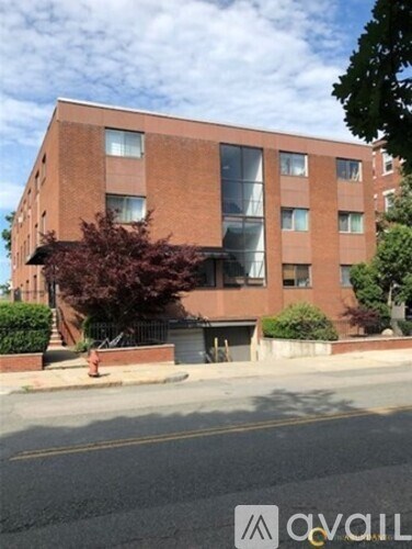 A brick building with a tree in front of it.