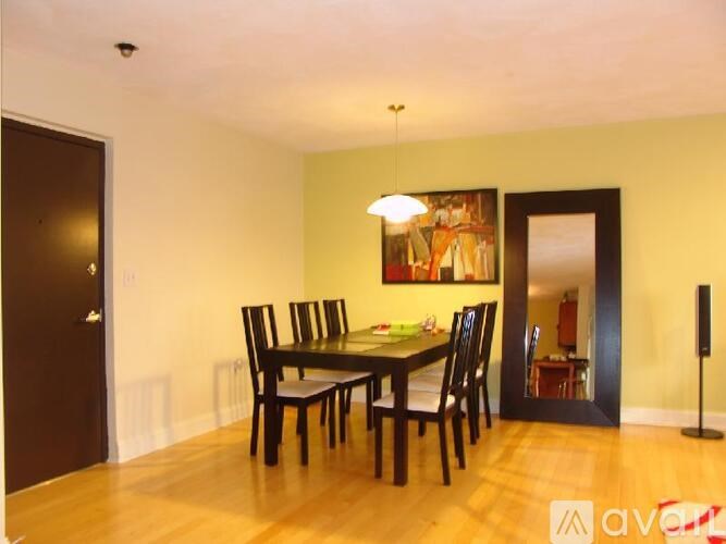 A dining room with a table and chairs.