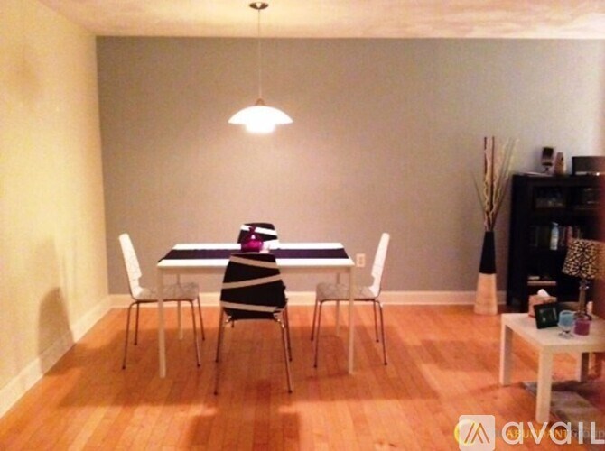 A dining room with a table and chairs.