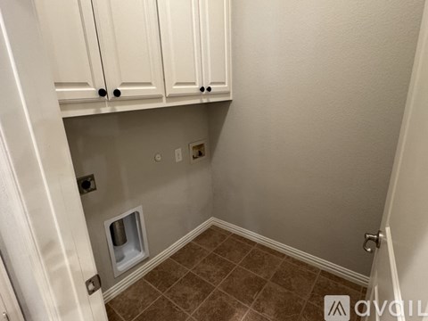 A white kitchen cabinet with a small opening in the middle.