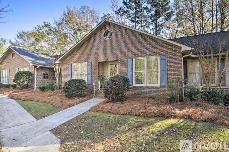 A brick house with a driveway in front.