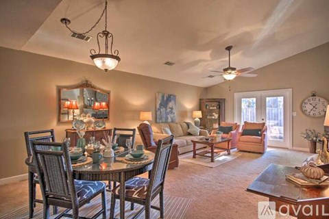 A well-lit dining room with a table set for six.