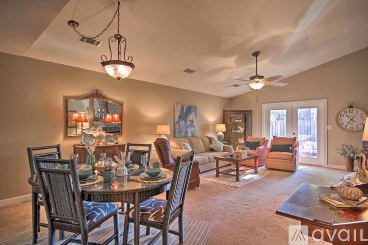 A well-lit dining room with a table set for six.