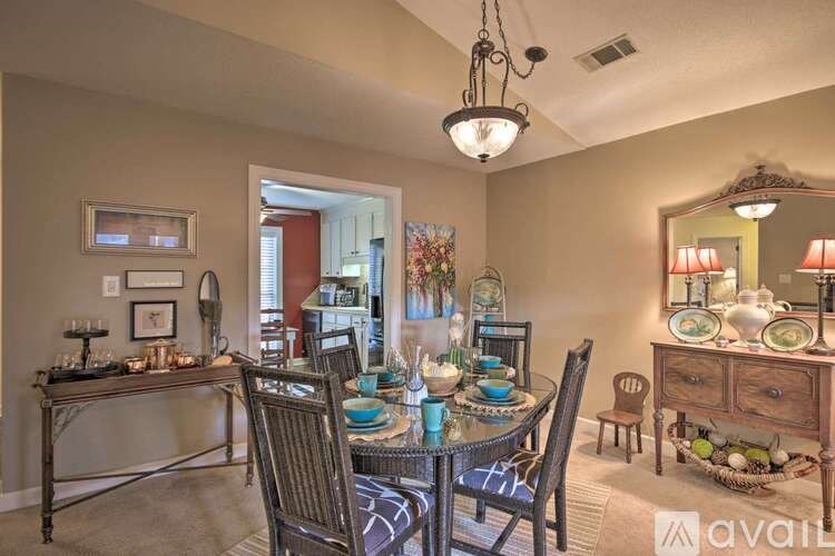 A dining room with a table set for six.
