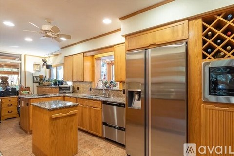 A kitchen with wooden cabinets and stainless steel appliances.