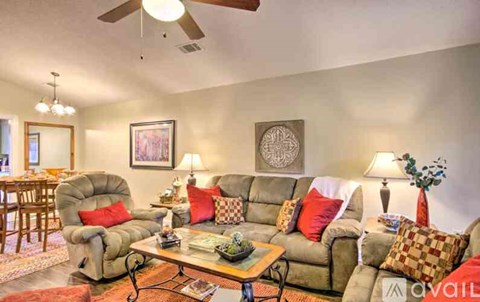 A living room with a grey sofa and a coffee table.