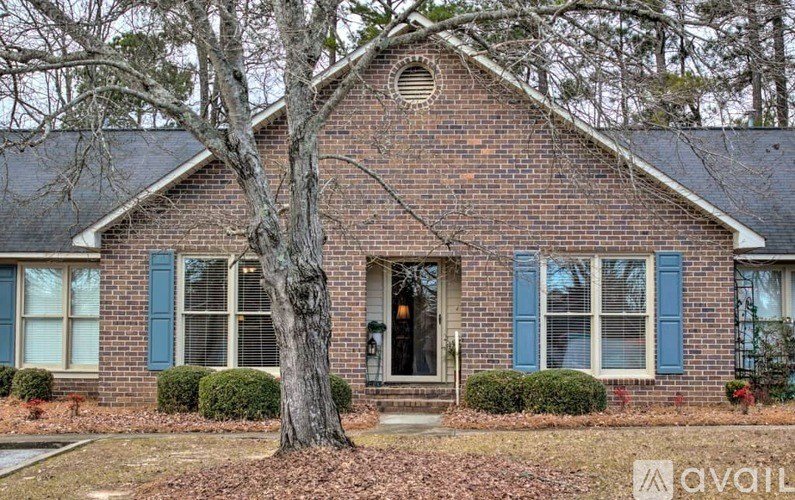 A house with a tree in front of it.