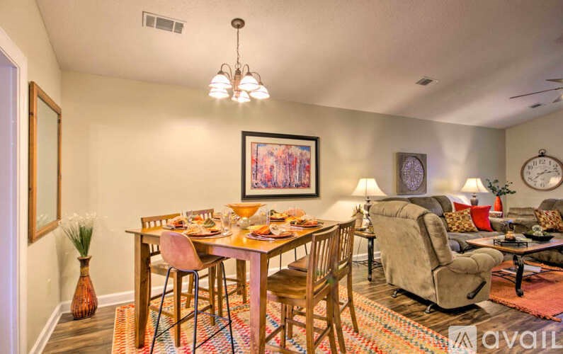 A dining room with a table set for a meal.