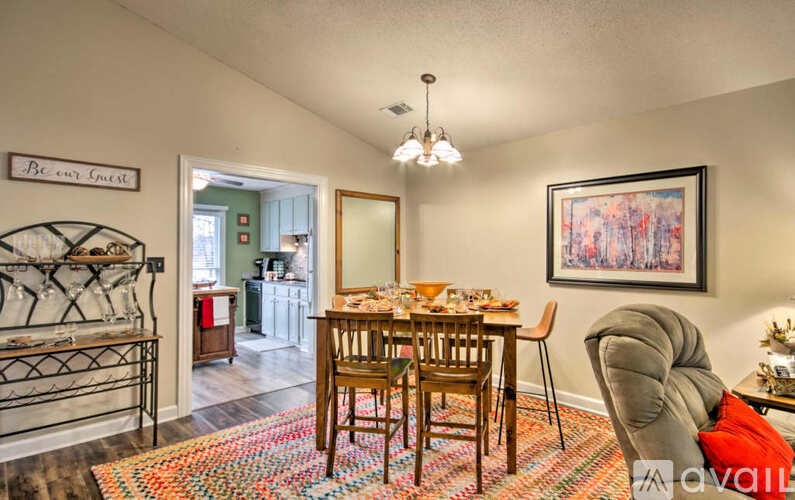 A dining room with a wooden table and chairs.