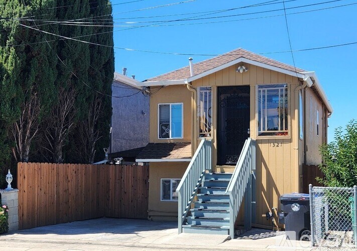 A small house with a wooden fence in front.